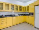 Modern kitchen with yellow cabinets and appliances