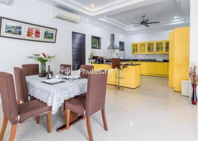 Modern kitchen and dining area with yellow cabinets