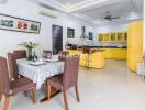 Modern kitchen and dining area with yellow cabinets