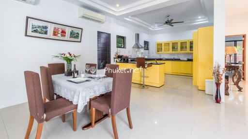 Modern kitchen and dining area with yellow cabinets