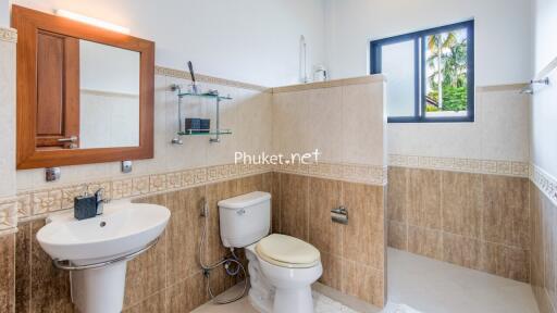 Modern bathroom with sink, toilet, mirror and window