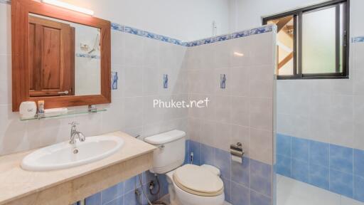 Bathroom with sink, mirror, and toilet