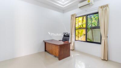 Home office with desk and window