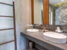 Modern bathroom with twin sinks and large mirror