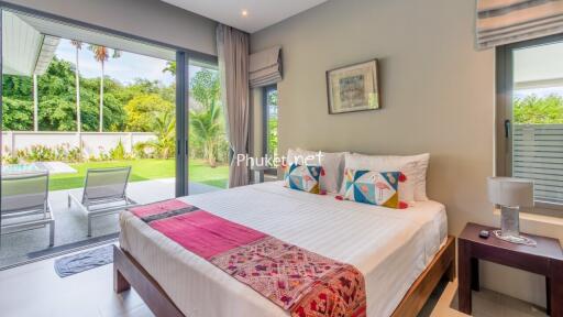 Modern bedroom with a view of the garden and pool