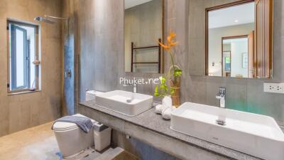 Modern bathroom with double sinks and walk-in shower