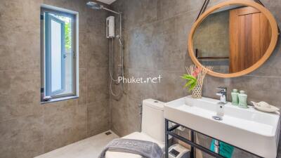 Modern bathroom with shower, mirror, and sink