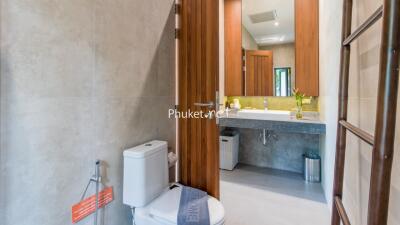 Modern bathroom with large mirror and wooden elements