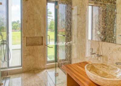 Luxurious bathroom with glass shower and stone sink