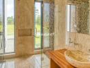 Luxurious bathroom with glass shower and stone sink