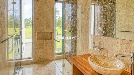 Luxurious bathroom with glass shower and stone sink