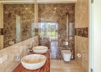 Luxurious bathroom with marble walls and modern fixtures