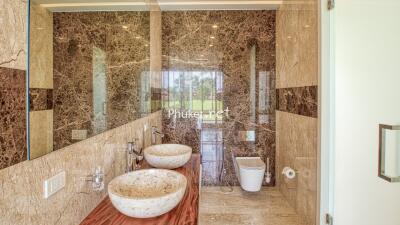 Luxurious bathroom with marble walls and modern fixtures