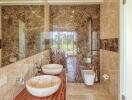 Luxurious bathroom with marble walls and modern fixtures