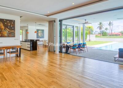 Spacious living and dining area with pool view