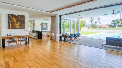 Spacious living and dining area with pool view