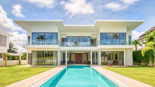 Front view of a modern two-story house with swimming pool