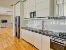 Modern kitchen with white cabinetry and stainless steel appliances