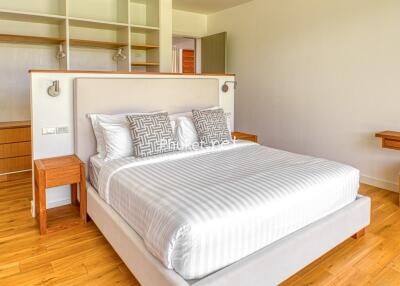 Bright and spacious bedroom with a large bed and built-in shelving