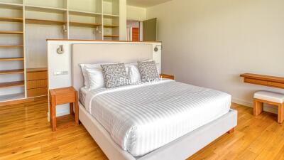 Bright and spacious bedroom with a large bed and built-in shelving