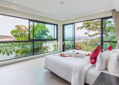 Spacious bedroom with large windows and a beautiful view