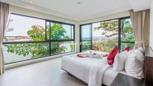 Spacious bedroom with large windows and a beautiful view