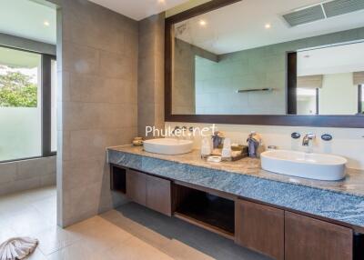 Modern bathroom with dual sinks and large mirror