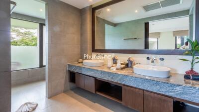 Modern bathroom with dual sinks and large mirror