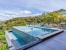 Modern outdoor pool with forested hillside view