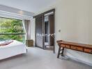 Bedroom with large window and forest view