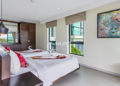 Modern, well-lit bedroom with twin beds and decorative elements