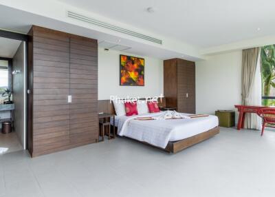 Spacious bedroom with modern decor and ample natural light