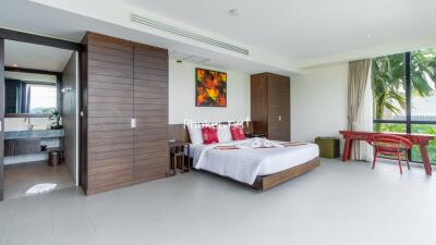 Spacious bedroom with modern decor and ample natural light