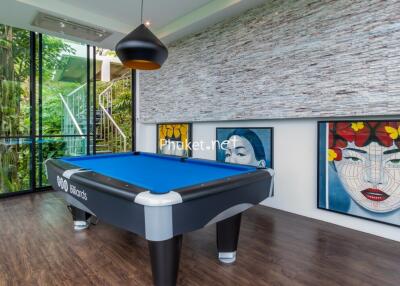 Modern entertainment room with a billiard table and large colorful artwork