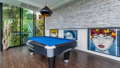 Modern entertainment room with a billiard table and large colorful artwork