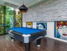 Modern entertainment room with a billiard table and large colorful artwork