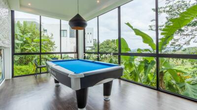 Modern recreation room with pool table and large windows with scenic views