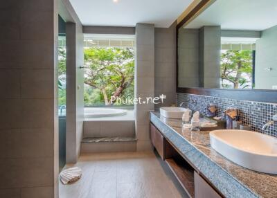 Modern bathroom with dual sinks and a bathtub