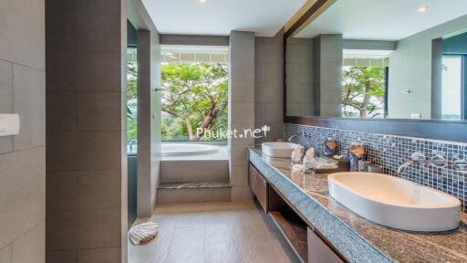 Modern bathroom with dual sinks and a bathtub