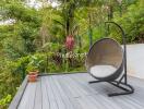 Cozy outdoor seating area with a modern chair overlooking lush greenery