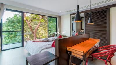 Modern bedroom with large windows and wooden furniture