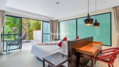 Bedroom with desk and sliding glass doors leading to outdoor area