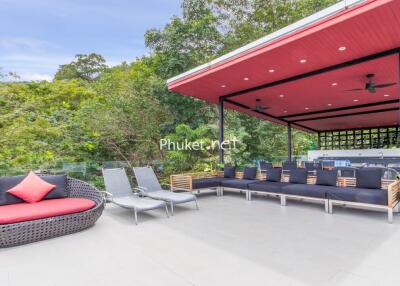 Spacious outdoor living area with modern seating and greenery.