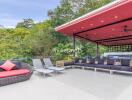 Spacious outdoor living area with modern seating and greenery.