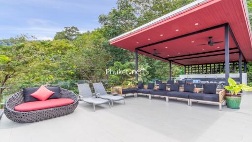 Spacious outdoor living area with modern seating and greenery.