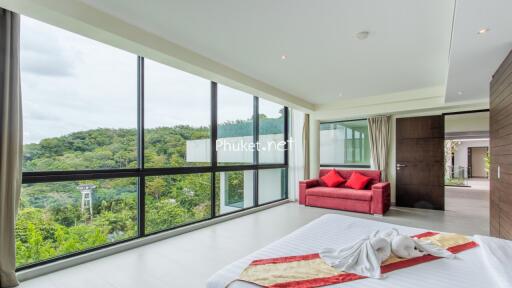 Modern bedroom with large windows and a scenic view