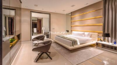 Modern bedroom with double bed, seating area, and stylish lighting