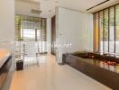 Contemporary bathroom with large black bathtub, wooden blinds, and modern fixtures