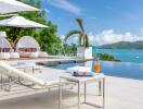 Outdoor lounging area with pool and scenic ocean view