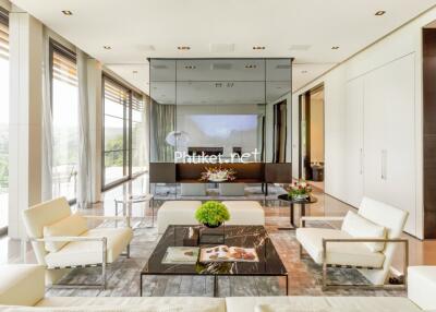 Modern living room with large windows and white furniture